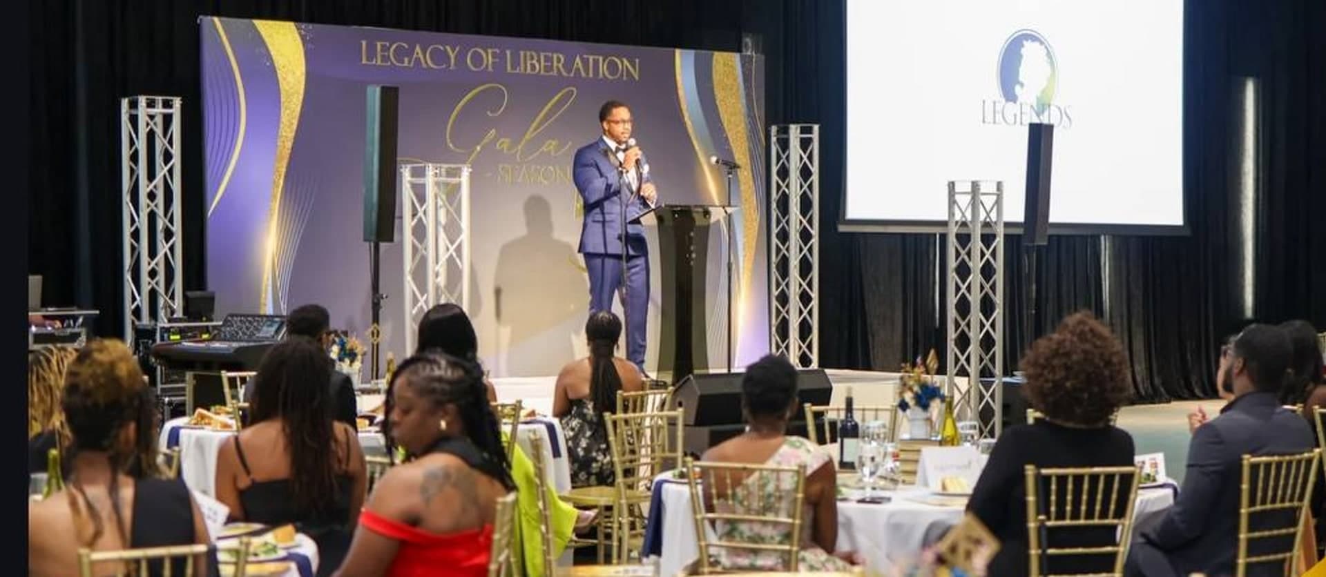 A speaker on stage before a full house at the Legends Legacy of Liberation Gala
